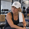 Woman wearing a white Radburn seal cap in a laboratory gym | color:White