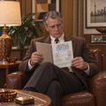 Man reading the World Peptide Conference 1974 notebook in an armchair | color:all