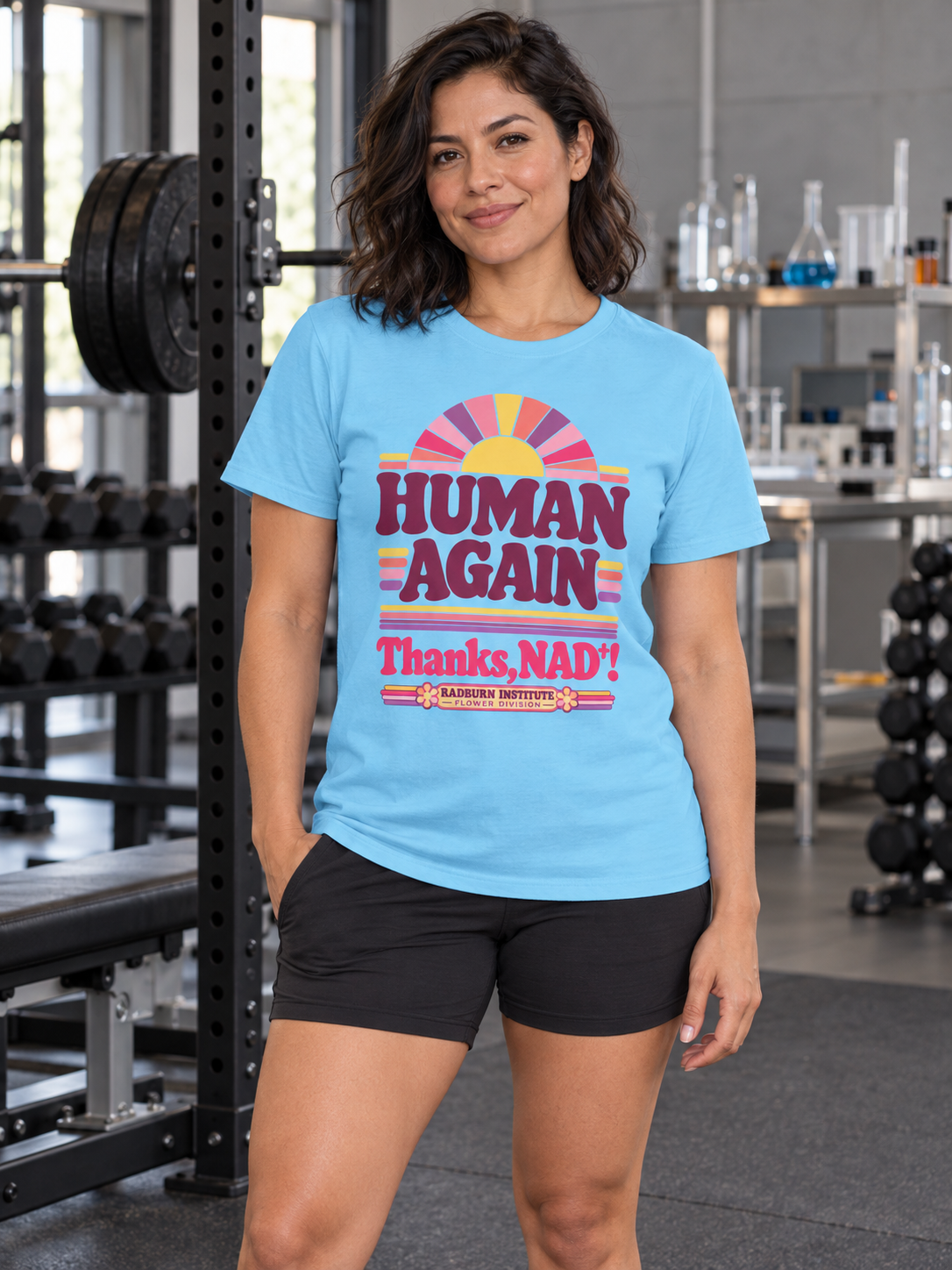 Woman wearing sky Human Again NAD+ T-shirt in a laboratory gym | color:Sky