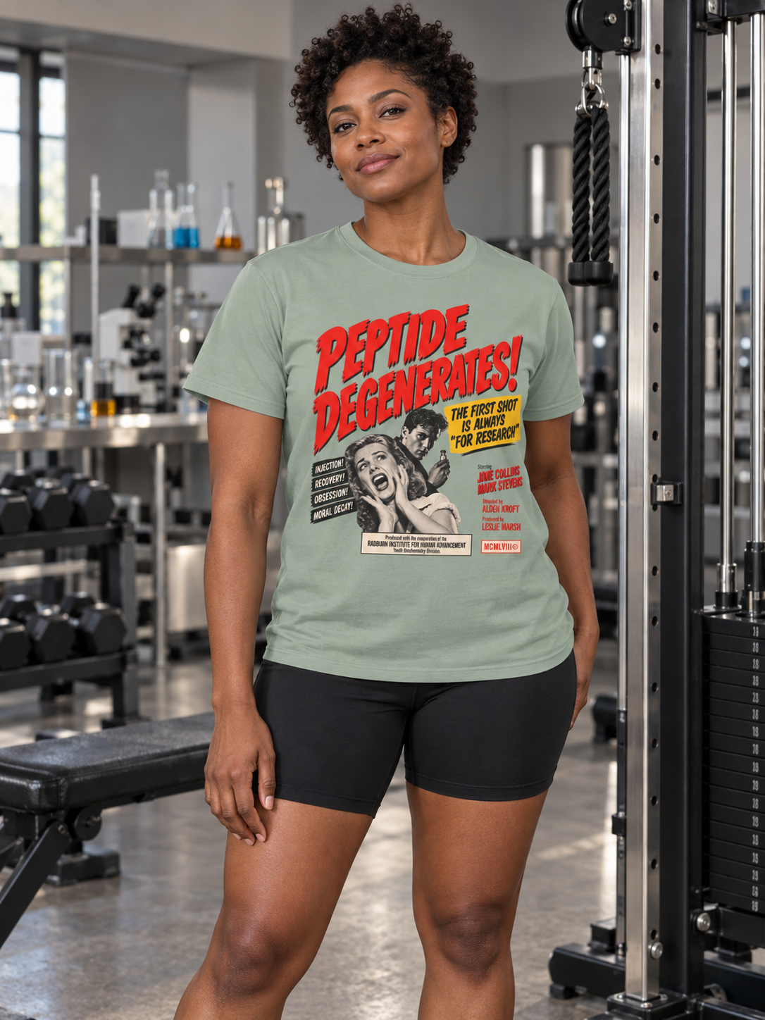 Woman wearing sage Peptide Degenerates in a laboratory gym | color:Sage